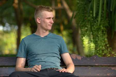 Young man with blond hair at the park outdoors