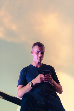 Portrait of young blond man against beautiful view of the sky