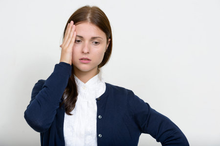 Portrait of young beautiful businesswoman against white background