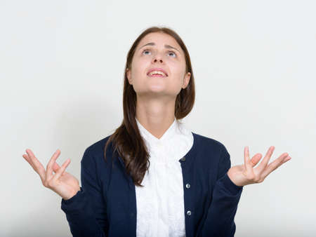 Portrait of young beautiful businesswoman against white backgroundの写真素材