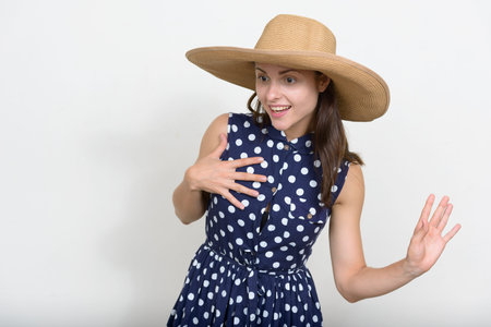 Portrait of young beautiful tourist woman against white background