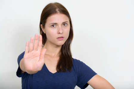 Portrait of young beautiful woman against white backgroundの写真素材