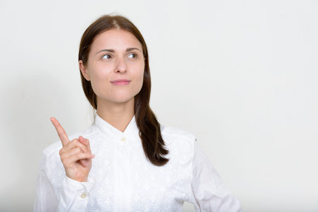 Portrait of young beautiful businesswoman against white background