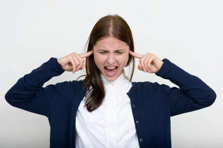 Portrait of young beautiful businesswoman against white backgroundの写真素材