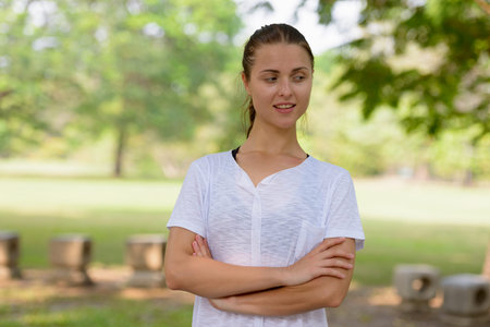 Young beautiful woman exercising at the park outdoors