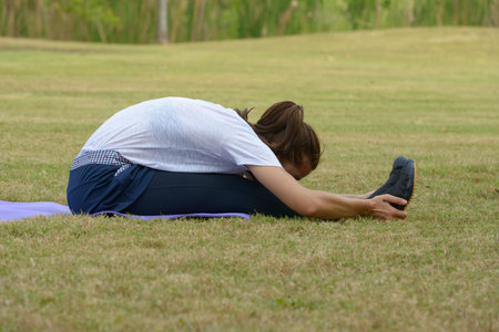 Young beautiful woman exercising at the park outdoors
