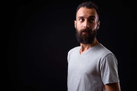 Young handsome Persian man with dreadlocks against black backgroundの写真素材