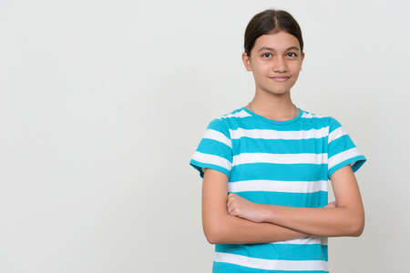 Portrait of young Asian teenage girl against white backgroundの写真素材