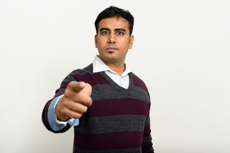 Portrait of handsome Indian man against white background