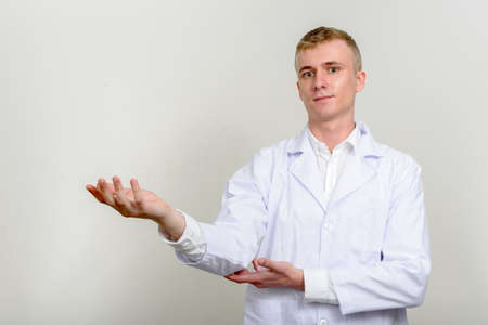 Portrait of young man doctor with blond hairの写真素材