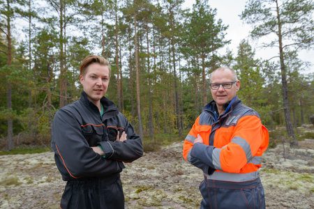 Portrait of mature man and young man together standing in the forest