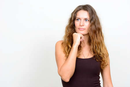 Portrait of young beautiful woman with curly blond hairの写真素材