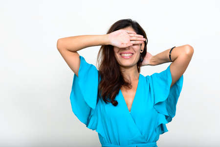 Portrait of happy young beautiful businesswoman covering eyesの写真素材