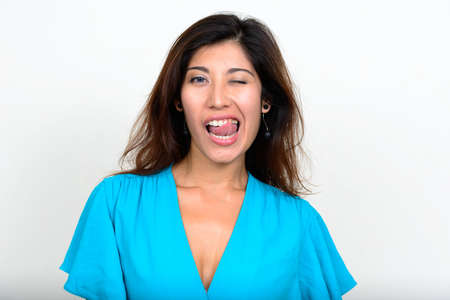 Portrait of happy young beautiful businesswoman winkingの写真素材