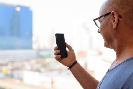 Senior handsome Scandinavian man inside the room by the windowの写真素材