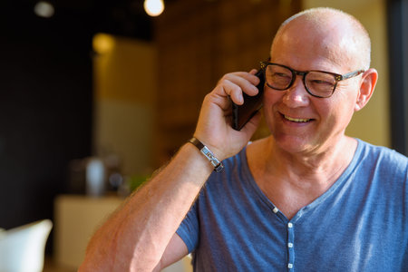 Senior handsome Scandinavian man relaxing inside the coffee shop