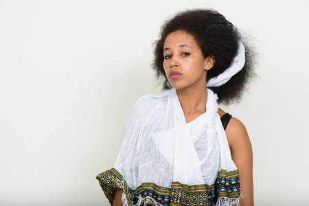 Portrait of young beautiful African woman with Afro hair in traditional clothing