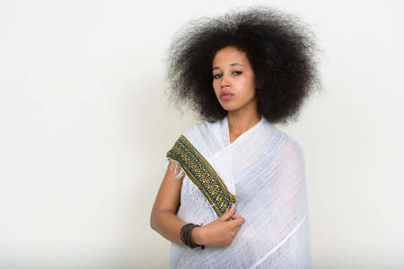 Portrait of young beautiful African woman with Afro hair in traditional clothingの写真素材