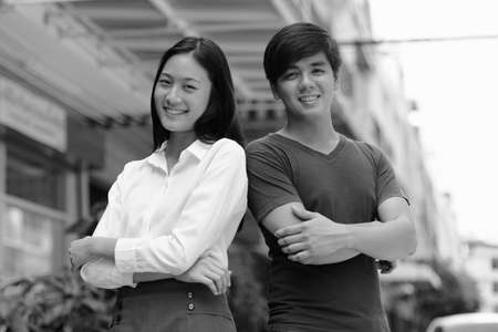 Portrait of young Asian couple together outdoors in black and whiteの写真素材