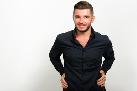Studio shot of handsome bearded Hispanic businessman
