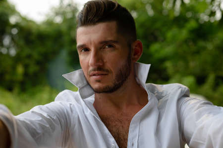 Portrait of handsome bearded Hispanic tourist man outdoorsの写真素材