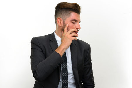 Portrait of handsome bearded Hispanic businessman in suit