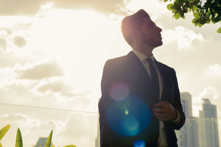 Handsome bearded Hispanic businessman against view of the cityの写真素材