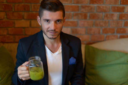 Handsome bearded Hispanic businessman at the coffee shopの写真素材