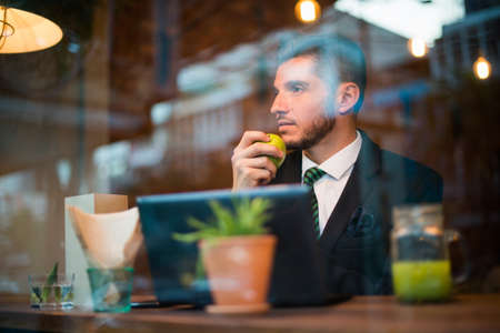 Handsome bearded Hispanic businessman at the coffee shopの写真素材