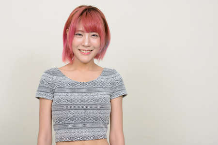 Young beautiful Asian woman with pink hairの写真素材