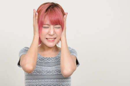 Young beautiful Asian woman with pink hairの写真素材