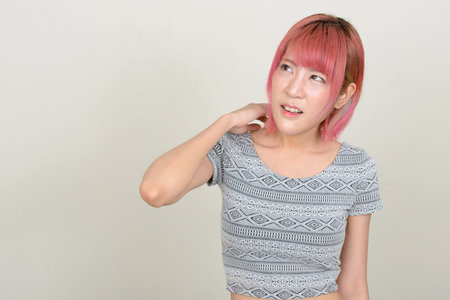 Young beautiful Asian woman with pink hair