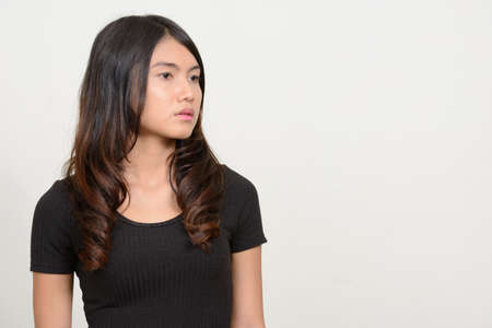 Portrait of young beautiful Asian woman thinkingの写真素材