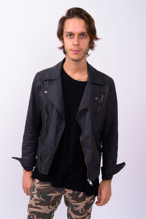 Young handsome rebellious man against white background