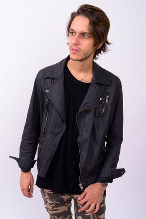 Young handsome rebellious man against white background