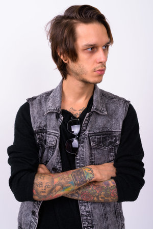 Young handsome rebellious man against white background