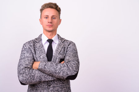 Handsome businessman with blond curly hair against white background