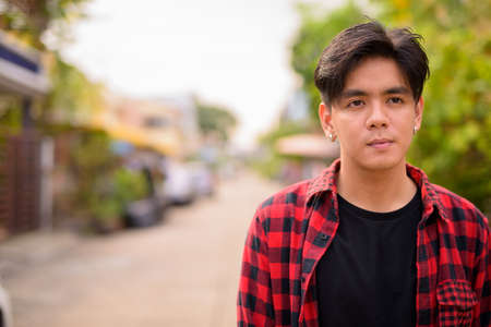 Young handsome Asian hipster man in the streets outdoorsの写真素材
