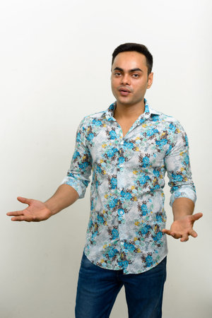 Portrait of young handsome Indian hipster man