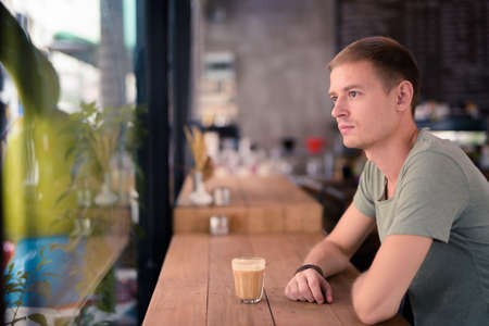 Handsome man relaxing in the coffee shopの写真素材