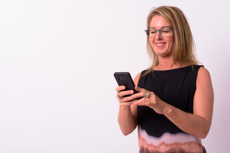 Mature beautiful blonde businesswoman against white background