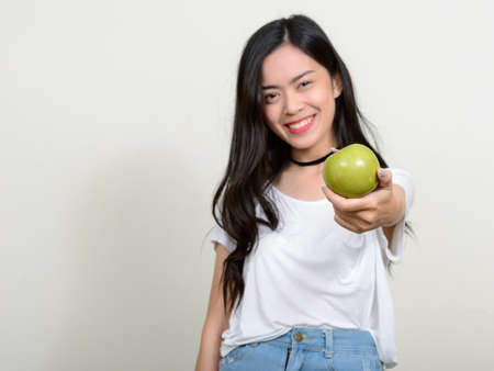 Portrait of happy young beautiful Asian womanの写真素材