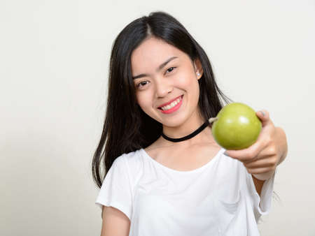 Portrait of happy young beautiful Asian womanの写真素材