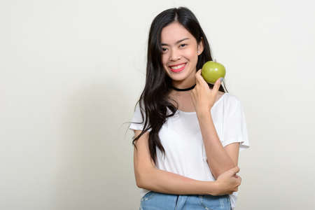 Portrait of happy young beautiful Asian womanの写真素材