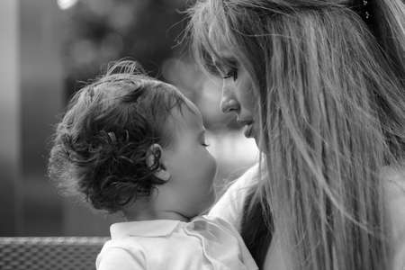 Young beautiful blonde mother with adorable baby son togetherの写真素材