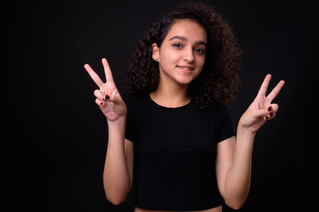 Portrait of young beautiful Persian teenage girl with curly hair