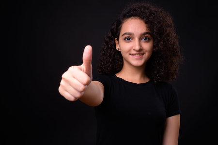 Portrait of young beautiful Persian teenage girl with curly hair
