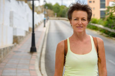 Mature beautiful tourist woman in the streets outdoorsの写真素材