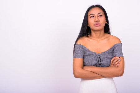 Young beautiful Asian woman against white background