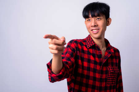 Portrait of happy young handsome Asian hipster manの写真素材